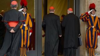 Swiss guard salutes as Cardinals arrive at the Vatican. Photo: 8 March 2013