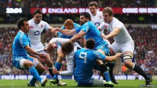 Toby Flood of England is tackled during match against Italy