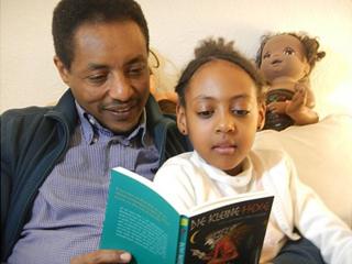 Mekonnen Mesghena reads The Little Witch with his daughter