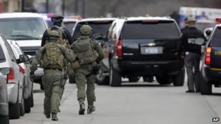 Emergency crews work at a car wash in the village of Herkimer, New York state after shootings at two different businesses
