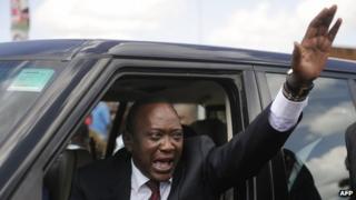Uhuru Kenyatta waves to a crowd on 10 March 2013 in Nairobi