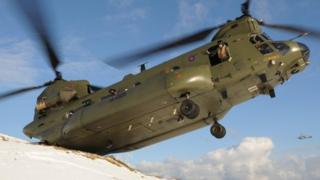 Military helicopter in operation during severe weather conditions in Northern Ireland