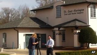 A journalist stands outside the dental practice of Dr W Scott Harrington in Tulsa, Oklahoma 28 March 2013