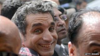 Egyptian satirist and television host Bassem Youssef is surrounded by his supporters upon his arrival at the public prosecutor's office in the high court in Cairo
