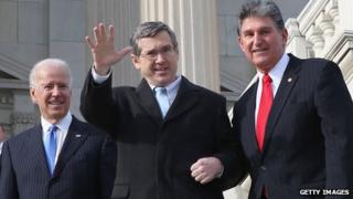 Nearly a year after suffering an major stroke, US Sen Mark Kirk (R-IL) (centre) climbs the steps to the US capitol 3 January 2013