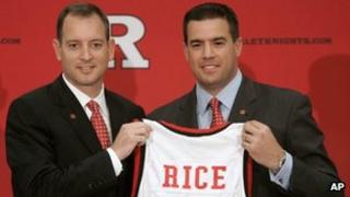 Rutgers athletic director Tim Pernetti, right, presents Mike Rice with a jersey after Rice was introduced as the school's men's basketball coach during a news conference in Piscataway, New Jersey 6 May 2010