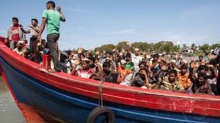 Indonesian policemen evacuate about Rohingya Muslims from Myanmar in Banda Aceh on April 8, 2013.