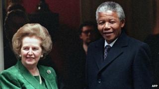 A picture dated 4 July 1990 shows South African anti-apartheid leader Nelson Mandela (R) shaking hands with then British Prime Minister Margaret Thatcher on the steps of No 10 Downing Street