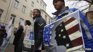 Protesters hold placards suggesting election monitoring non-governmental body Golos is an agent of the US during a protest against the organisation outside its offices in Moscow last Friday