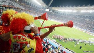 Spanish fans blow vuvuzelas during the 2010 World Cup