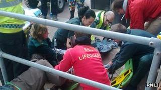 Lifeguards attend injured kite surfer