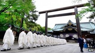 Shinto priests walk in line to the main shrine during the three-day annual spring festival at the Yasukuni Shrine in Tokyo on 21 April 2013