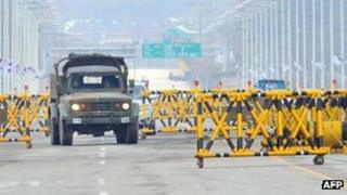 A South Korean military vehicle drives past barricades on the road leading to North Korea's Kaesong industrial complex, at a military checkpoint in the border city of Paju on 25 April 2013