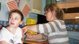 Sophie Hayes, 13, from Townhill, Swansea, receives MMR from Health Visitor Jo Lamb.