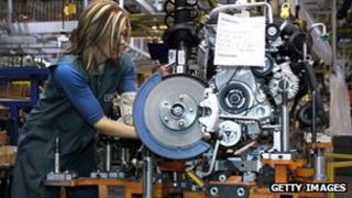 A worker builds an engine for a Ford Focus on the assembly line at Ford Motor's Michigan Assembly Plant in Wayne, Michigan.