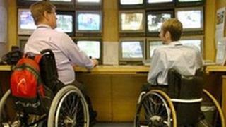 Two wheelchair users at work