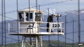 File image from from 8 March 2013 shows a UN peacekeeper using binoculars on an observation tower in the largely abandoned city of Quneitra, in the demilitarized United Nations Disengagement Observer Force (UNDOF) zone, in the Golan Heights