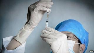 Doctor holding a syringe