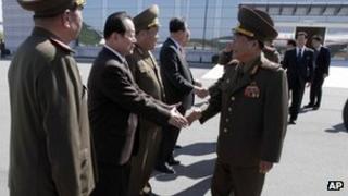 Choe Ryong-hae, front right, shakes hands with officials as he departs for China on 22 May 2013
