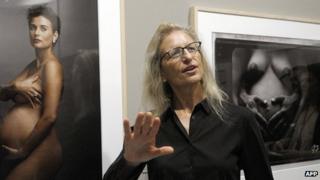 Annie Lebovitz next to her picture of actress Demi Moore
