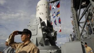 Commander Huang I-che watches ships from the deck of a Taiwanese Kidd-class destroyer during exercises off of the southern city of Kaohsiung, Taiwan on 15 May 2013