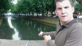 Rob Pritchard - nicknamed 'Paddles' - points towards a duck pond