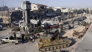 A general view shows soldiers loyal to the Syrian regime with their military tanks in Qusair