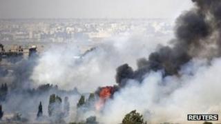 Smoke rises after fighting near the Quneitra crossing on the Golan Heights