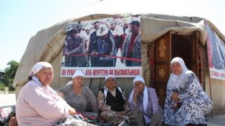 Elderly Kyrgyz women sitting near a traditional yurt in Jalalabad, Kyrgyzstan
