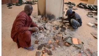 Men recover burnt ancient manuscripts at the Ahmed Baba Centre for Documentation and Research in Timbuktu, January 2013