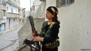 A rebel fighter holds a weapon in Aleppo