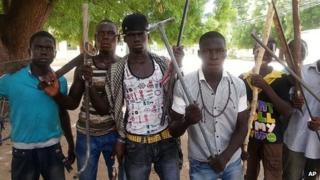 Vigilantes youths pose for a photographs in Maiduguri, Nigeria. 11 June 2013