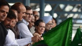 Indian Prime minister Manmohan Singh (R) and Congress party President Sonia Gandhi (2nd R) flag off a train service running between Banihal and Qazigund at a station in Banihal, some 110 kms south of srinagar, on June 26, 2013.
