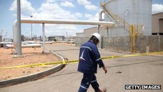 An oil worker walks in an oil production facility in Paloch in South Sudan's Upper Nile state
