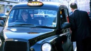 Man getting into a black taxi