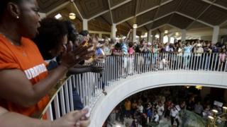 Protestors and supporters gather around the balcony overlooking the House and Senate floors during a demonstration at the state legislature in Raleigh, North Carolina 17 June 2013