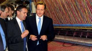 David Cameron, right learns about the carpet weaving process from Ulster Carpet Mills MD Nick Coburn