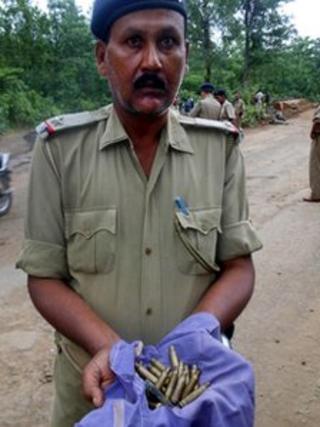 A policeman shows ammunition used in the Maoist attack