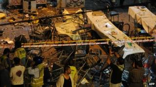 Chairs and tables are strewn across a street in Lahore following a bomb which killed at least three people