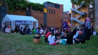 People sharing iftar, the sunset meal, after breaking the fast