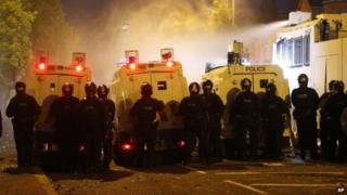 Riot police deploy a water cannon after being attacked by loyalist protesters in north Belfast.