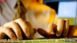 Man typing on computer keyboard