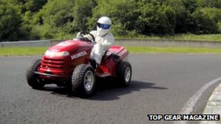 The Stig driving a lawn mower