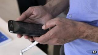 Iranian holding a mobile phone