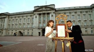 A notice formally announcing the birth of a son to Prince William and Catherine, Duchess of Cambridge, is erected in the forecourt of Buckingham Palace