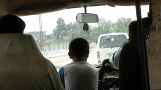 Edhi officials search for house of lost boy Shan, sitting centre, in Islamabad