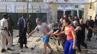 Turkish embassy staff carry a wounded person after a car bomb attack in Somalia's capital Mogadishu, on 27 July, 2013