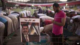 Morsi supporter prays during a sit-in protest in Cairo (5 August 2013)