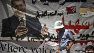 An Egyptian child walks at a sit-in by members of the Muslim brotherhood and supporters of ousted Egyptian President Mohammed Morsi outside the Rabaa al-Adawiya mosque on the first day of Eid al-Fitr celebrations (8 August 2013)