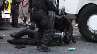 Injured police officer on the ground during loyalist protest in Belfast